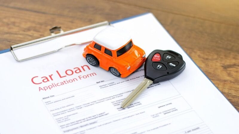 Image showing car loan application, with new car keys and toy car