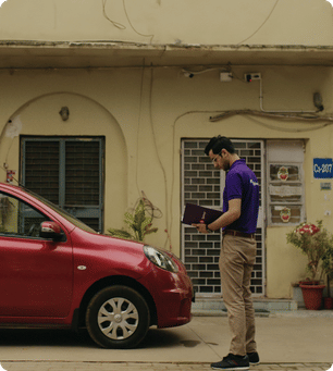 A person inspecting their car before selling.